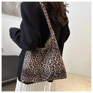 Fashion model wearing a large leopard print tote bag with stylish black blazer outfit