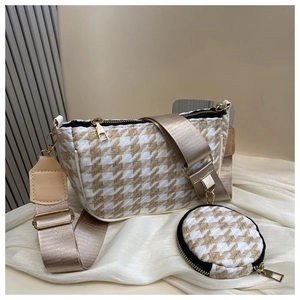 Detail of houndstooth crossbody bag with round pouch and champagne canvas strap