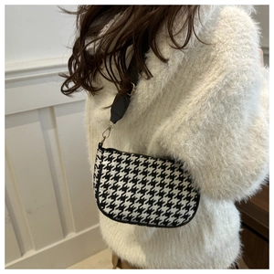 Classic houndstooth shoulder bag for women with elegant black trim and golden metal hardware