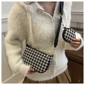 Detail view of houndstooth crossbody bag set with wide strap and coin purse