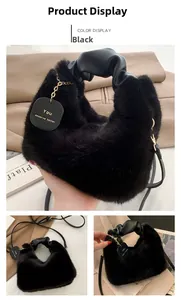 Detail of black faux fur handbag with ruched leather handle and engraved gold-tone charm