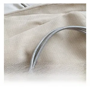 Detail shot of silver metallic shoulder straps on a stylish bow crossbody bag