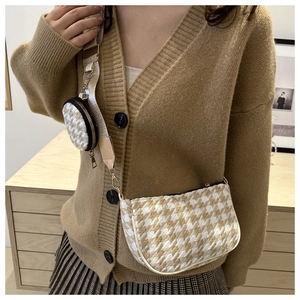 Detail of houndstooth crossbody bag with wide strap and matching round coin purse pouch
