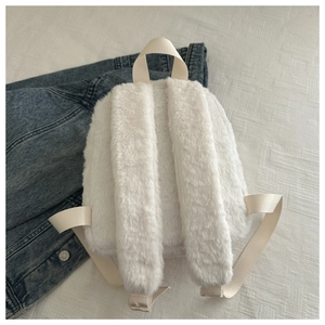 Detail of soft white faux rabbit fur mini backpack with plush straps and nylon handle