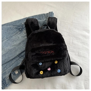 Detail of black plush faux fur mini backpack with FASHION embroidery and colorful buttons