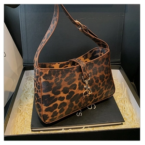 Detail of leopard print hobo bag featuring a gold piston clasp and adjustable strap