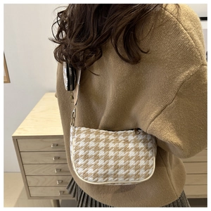 Chic houndstooth shoulder bag with mini pouch shown on camel knit sweater