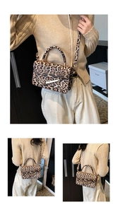 Detail view of leopard print crossbody bag with gold hardware and versatile straps