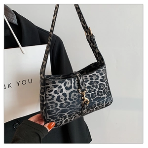 Detail of grey leopard print handbag with vintage gold buckle and stylish chain strap