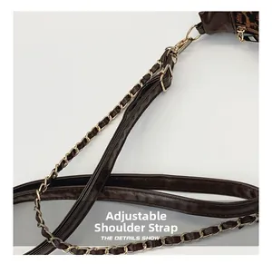 Detail of adjustable dark brown leather and gold metal chain shoulder strap for bags