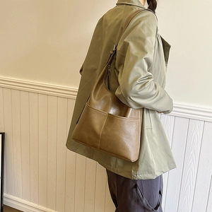 Retro brown large capacity tote bag shown on a model with minimalist stitching detail