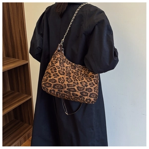 Detail view of leopard print hobo bag showing faux fur texture and chain leather strap