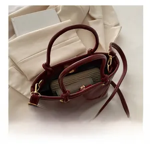 Interior view of wine red glossy bucket bag showing spacious capacity for wallet and cosmetics