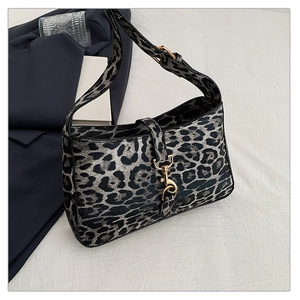 Close-up of leopard print shoulder bag with gold clasp and textured synthetic leather