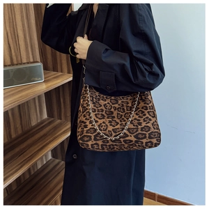 Detail of leopard print crossbody bag featuring soft suede texture and gold chain strap
