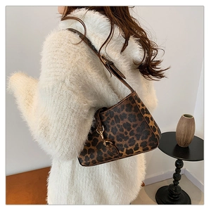 Fashion leopard print shoulder bag worn by model in minimalist interior setting