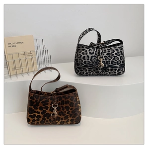 Detail of leopard print hobo bags in brown and grey with golden metal buckle clasp