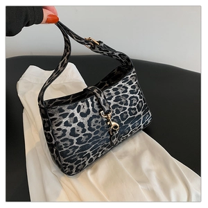 Close-up of leopard print baguette bag with gold metal buckle and adjustable PU leather strap
