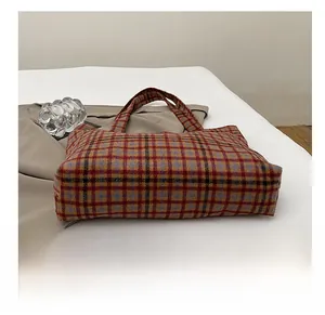 Detail shot of the durable plaid patterned tote bag with a vintage autumn aesthetic