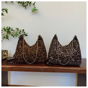 Retro leopard print hobo bags featuring metallic chain straps on a wooden surface