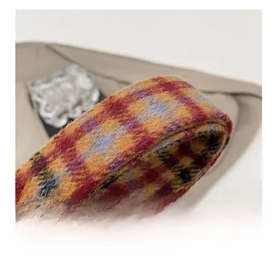 Detail of soft multi-color plaid shoulder strap with vintage fuzzy wool texture