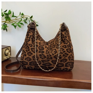 Close-up of leopard print hobo bag with gold chain detail and brown leather strap