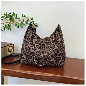 Detail of leopard print hobo bag with gold chain and black leather shoulder strap