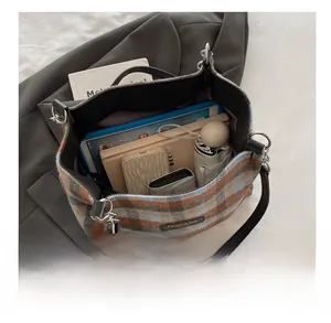 Interior view of checkered plaid tote bag showing its large capacity for daily essentials
