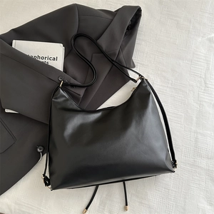 Minimalist large black tote bag in matte faux leather with elegant gold hardware