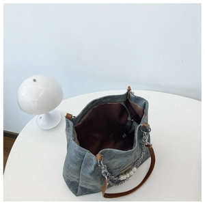 Spacious gray canvas tote bag interior with pearl chain and leather handles