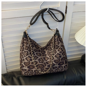 Detail of leopard print shoulder bag with gold chain and faux pony hair texture