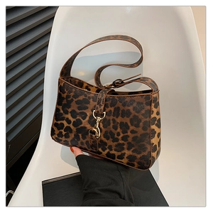 Detail of trendy leopard print handbag featuring premium gold metal hardware buckle
