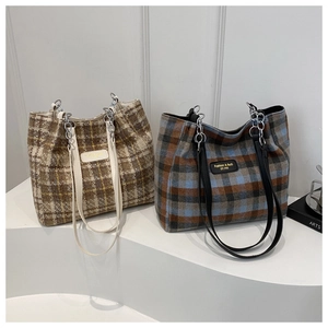 Detailed view of checkered wool tote bags with metal chain straps in brown and blue