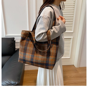 Detailed view of British plaid wool tote bag texture and reinforced double handles