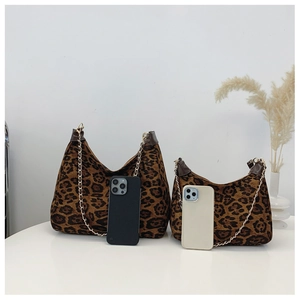 Detailed size comparison of leopard print chain bags with leather trim on white surface