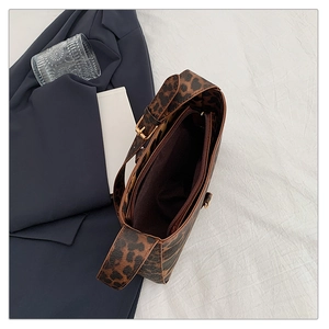 Internal view of leopard print shoulder bag showing inner zipper pocket and capacity