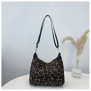 Detail of leopard print shoulder bag with gold zipper and adjustable black strap