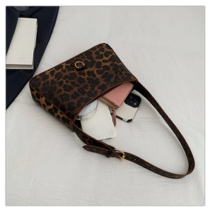 Top view showing interior capacity of leopard print shoulder bag with phone and wallet