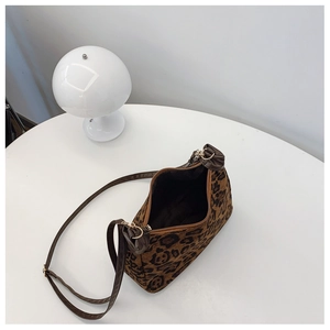 Detail view of the leopard print handbag showing the interior lining and zip closure