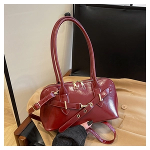 Top view of deep red patent leather handbag with dual straps and gold hardware