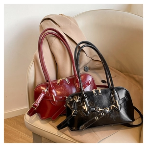 Detailed shot of vintage leather handbags in black and dark red on a soft chair