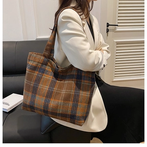 Detail of checkered tweed tote bag showing thick weave texture and secure button closure