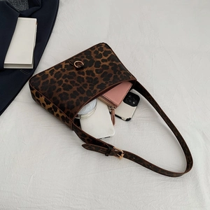 Leopard print underarm bag with gold hardware shown with phone and wallet inside