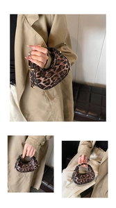 Close-up of leopard print crescent bag with premium gold zipper and leather texture