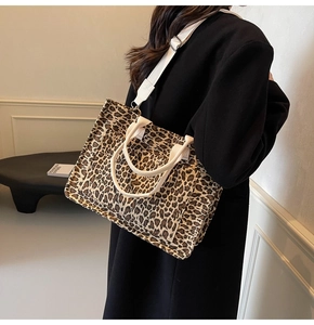 Detail of leopard print tote bag with a wide adjustable strap shown on a model