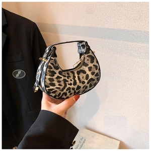 Close-up of leopard print crescent moon bag with premium gold zipper and fuzzy texture