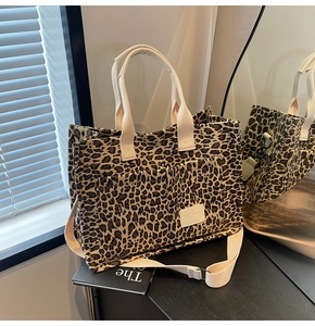 Detail of leopard print tote bag featuring front dual pockets and branded JINGPIN label