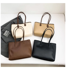 Flat lay of four leather tote bags in beige, khaki, brown, and black for daily commute