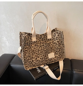 Detail shot of leopard print tote bag with adjustable strap and front pocket design