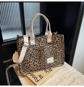 Detail of leopard print canvas tote bag with dual front pockets and adjustable straps